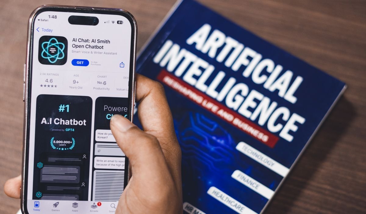 iPhone with various AI app icons on screen - best AI apps for iPhone in 2026