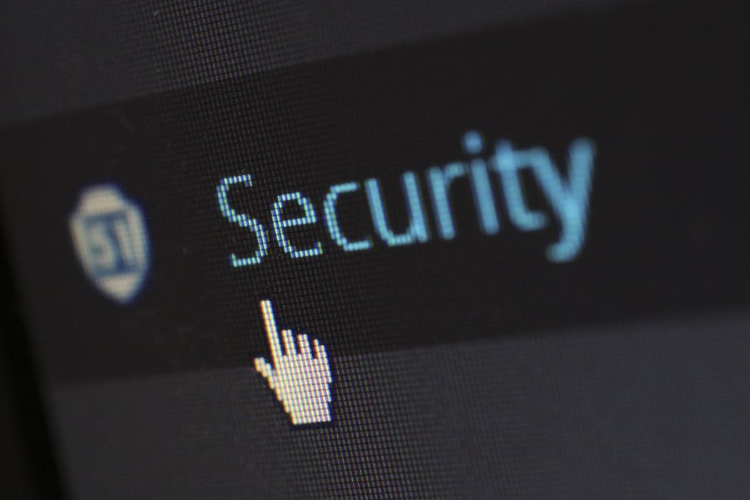 Computer security shield icon overlaid on laptop