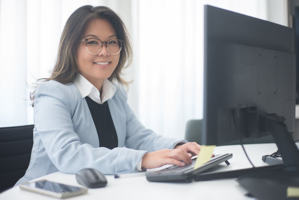Office documents and laptop showing PDF on screen