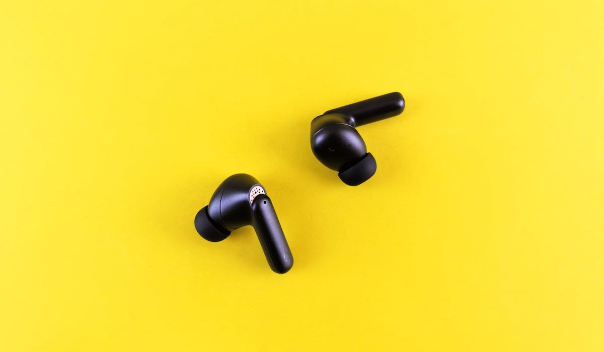 Wireless earbuds on table - best wireless earbuds under $100 in 2026