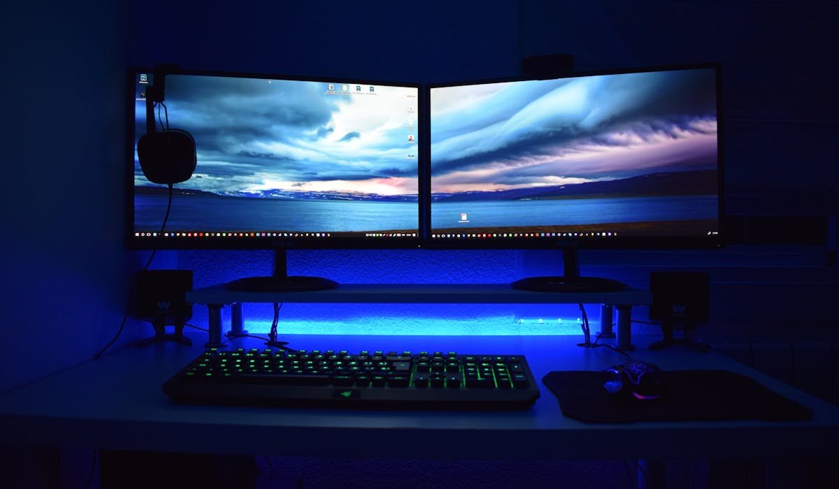 Two monitors connected to laptop on desk - how to set up dual monitors on Windows
