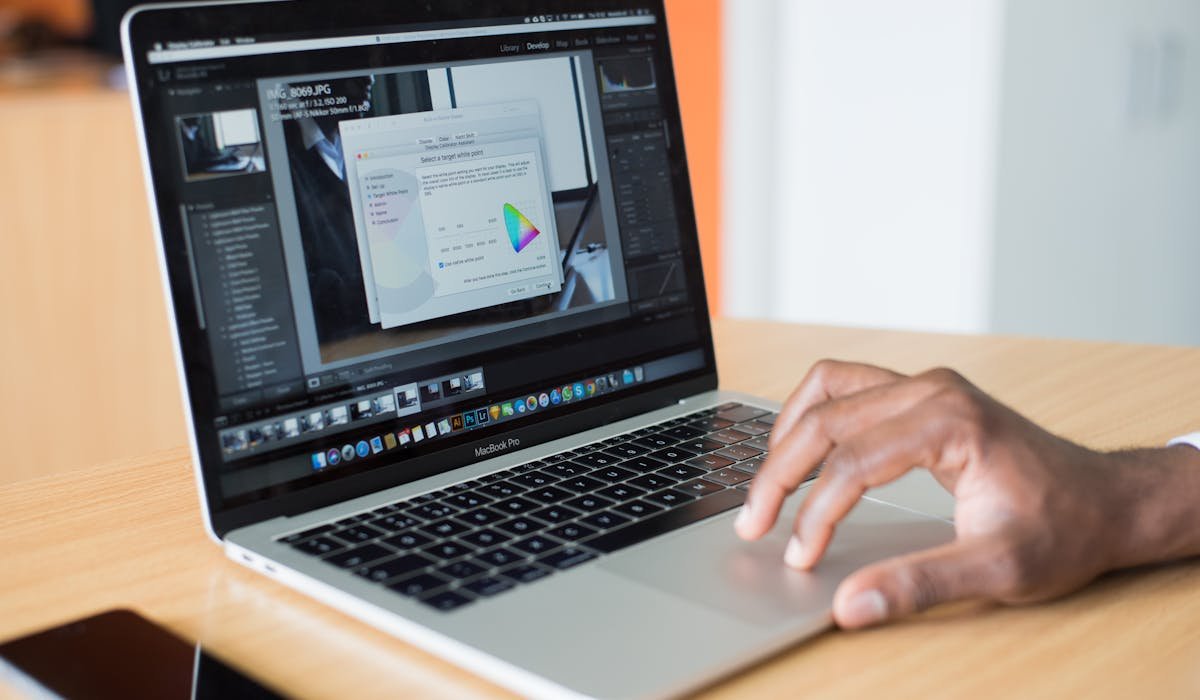 MacBook on desk with software update screen - how to update macOS