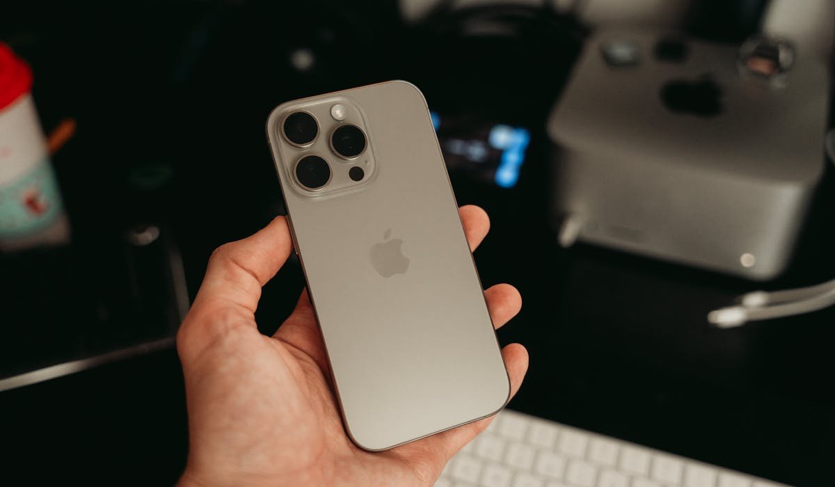 Hand holding iPhone 16 Pro showing camera - is iPhone 16 Pro worth it review